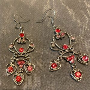 Sterling silver heart earrings with red diamonds.